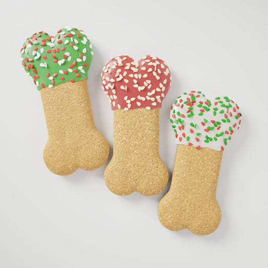 Peanut butter Party Bone dog cookies decorated with festive Christmas colors and sprinkles
