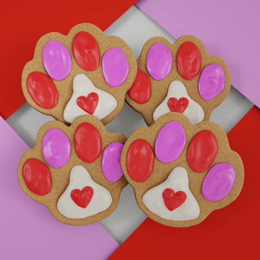 Four colorful handmade paw-print Valentine's day ginger cookies for dogs