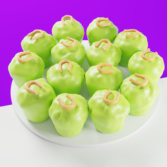 Fourteen light green mini Clip Clop cakes for horses with horseshoe icing decorations on a white platter