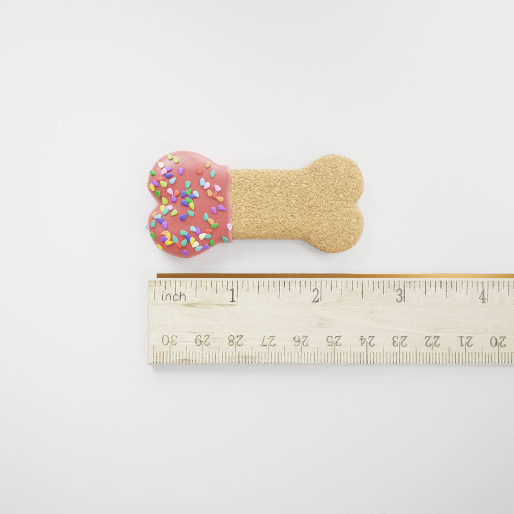 Small Party Bone dog cookie shown beside a ruler for size reference