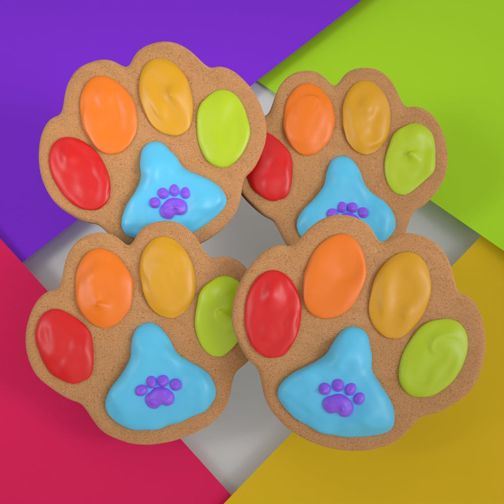 Four colorful handmade paw-print ginger cookies for dogs