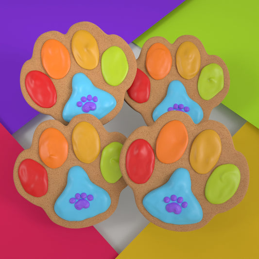 Four colorful handmade paw-print ginger cookies for dogs