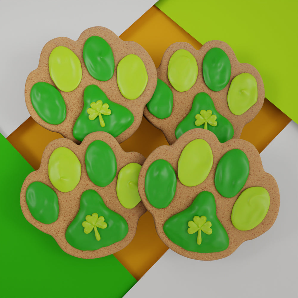 Four colorful handmade paw-print St Patrick's Day ginger cookies for dogs