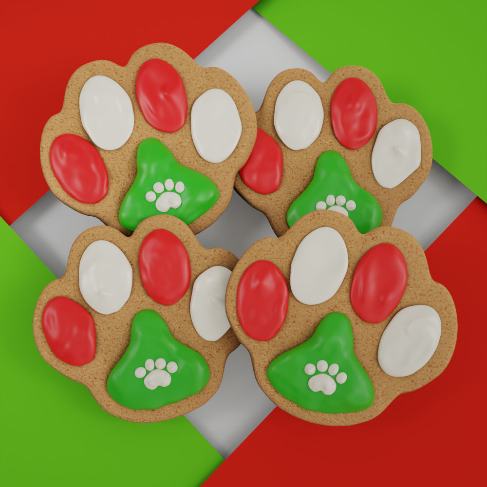 Four colorful handmade paw-print Christmas ginger cookies for dogs