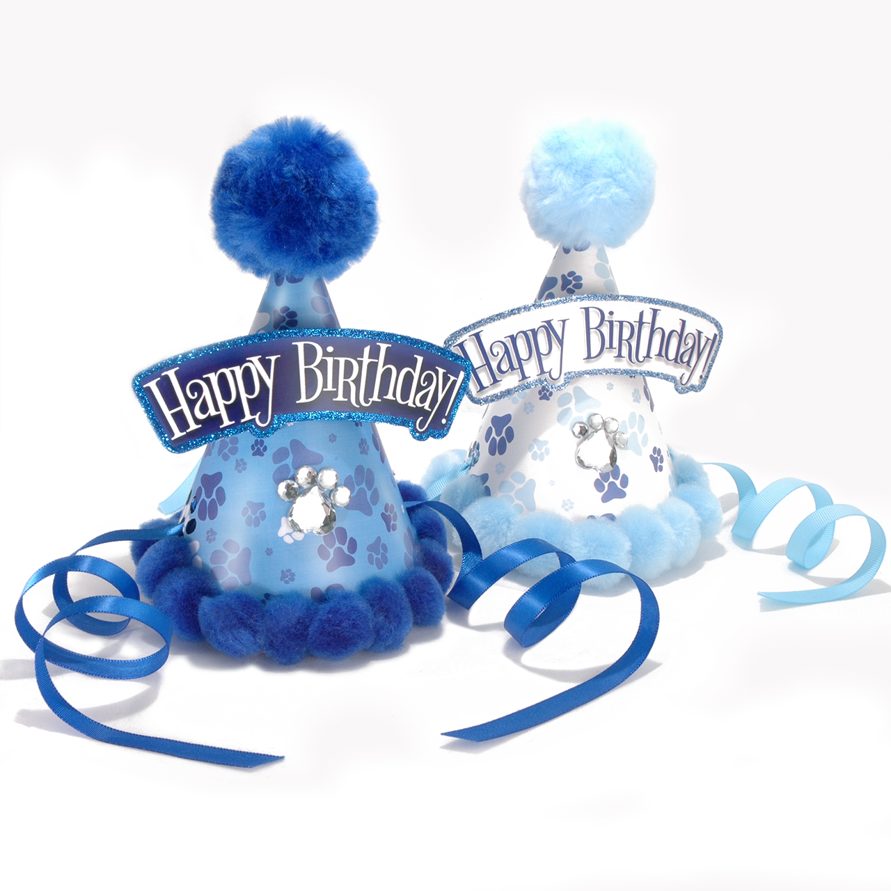 Two blue and white pet-themed party hats with fluffy pom-poms, paw print patterns, and 'Happy Birthday' banners, shown with blue and light blue ribbons on a white background.