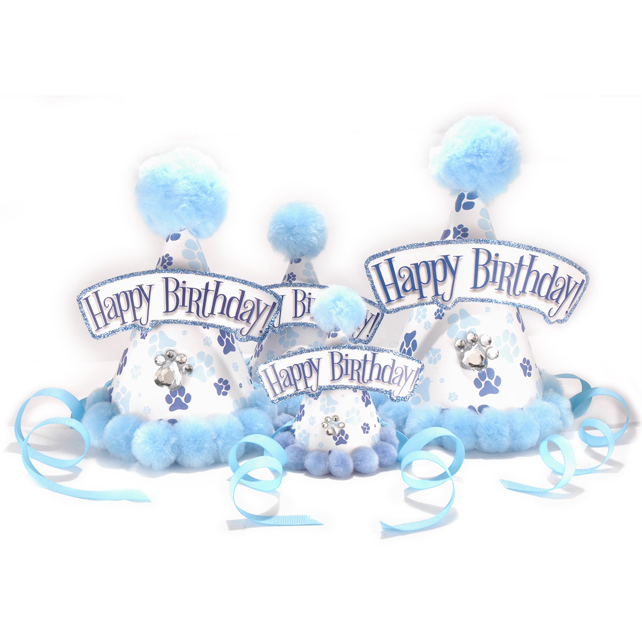 Three blue and white dog-themed birthday party hats with fluffy blue pom-poms, glittery blue 'Happy Birthday!' banners, paw prints, and small dog illustrations, arranged on a white background with light blue ribbons.