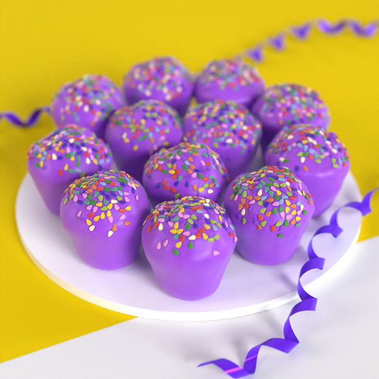Twelve purple mini PupCup cakes for dogs with rainbow sprinkles on a white platter against a yellow background