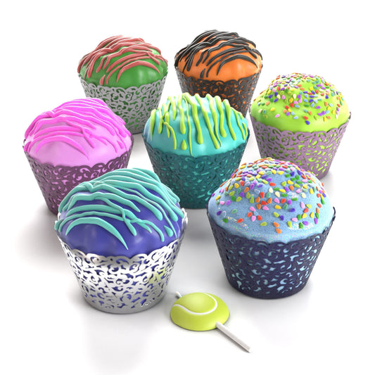 Assorted large PupCup cakes for dogs with colorful icing, drizzle, rainbow sprinkles, and patterned wrappers