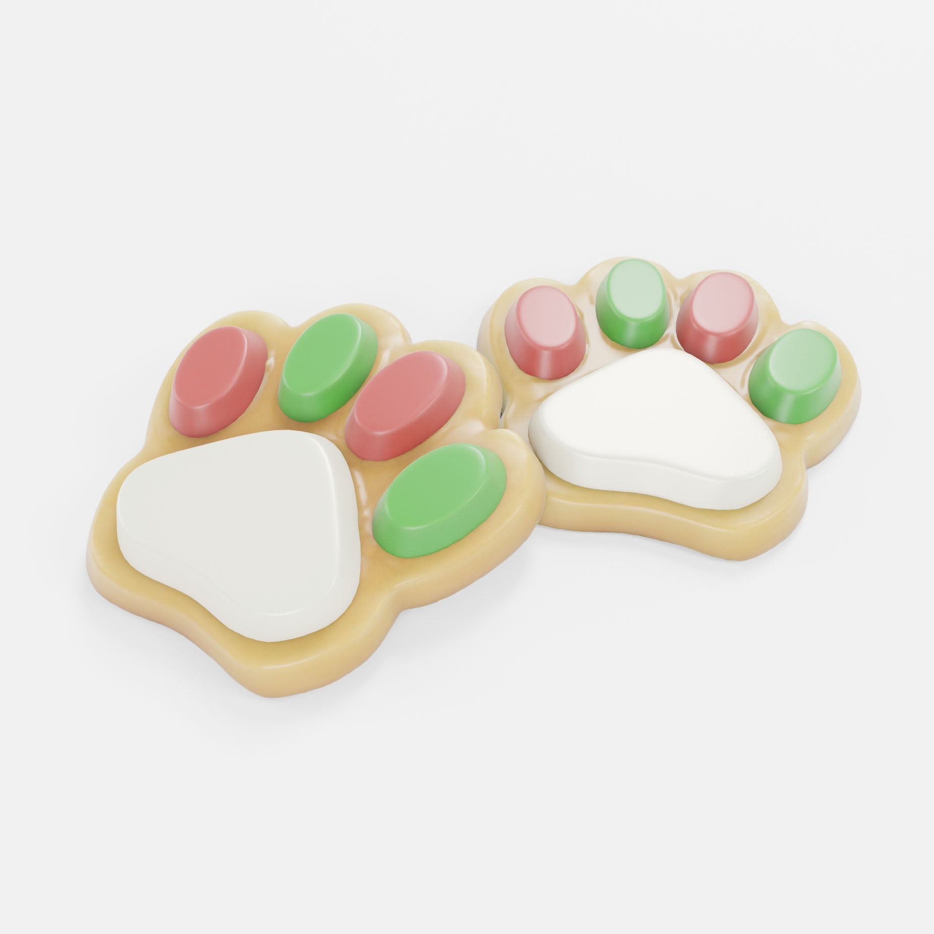 Two paw-shaped treats decorated with white, pink, green, and beige icing, set against a plain light gray background.